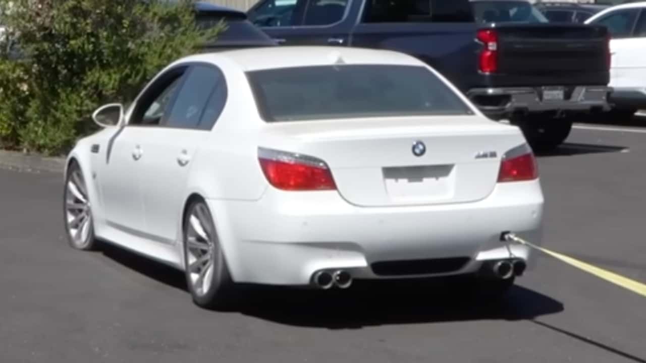 BMW M5 being flat towed by a minivan