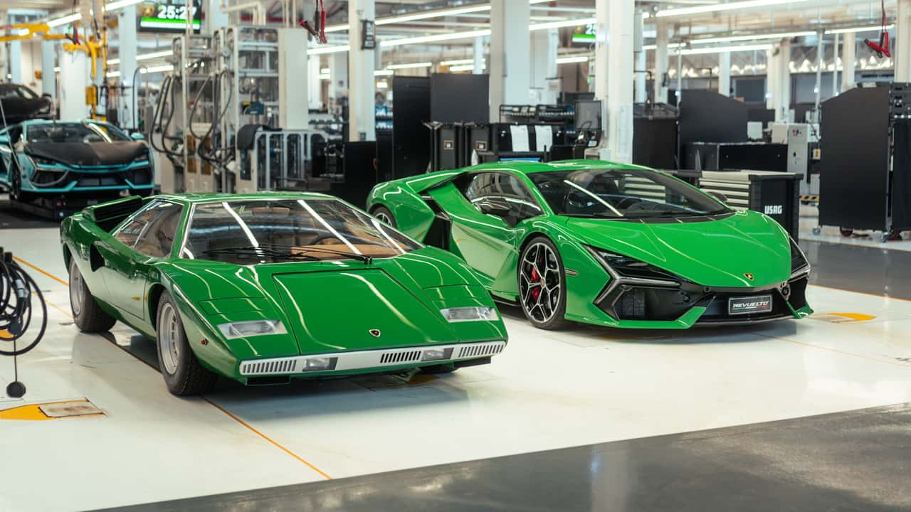 Front view of a green 1974 Lamborghini Countach and a new Lamborghini Revuelto.